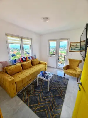 a living room with a couch and a table at Apartman Berlin Sokobanja in Soko Banja