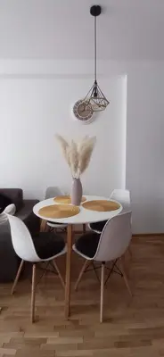 a dining room table and chairs with a vase on it at Planinska idila in Kopaonik