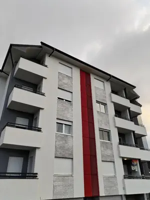 a building with a red stripe on it at HUGO APARTMAN Green Hill Kompleks- u blizini Akva Parka in Soko Banja