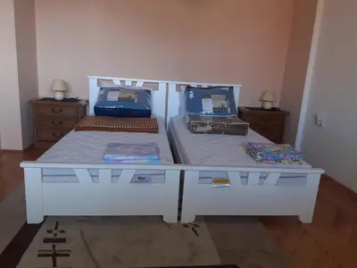 a bedroom with a white bed with two twin beds at NIKOLIĆ APARTMAN in Vranje