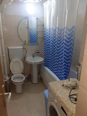 a bathroom with a toilet and a sink and a mirror at NIKOLIĆ APARTMAN in Vranje