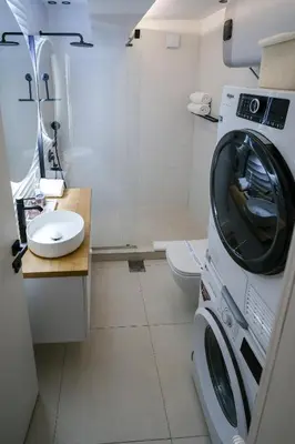 a bathroom with a washing machine and a toilet at Apartment in Niš, Center! brand-new in Niš