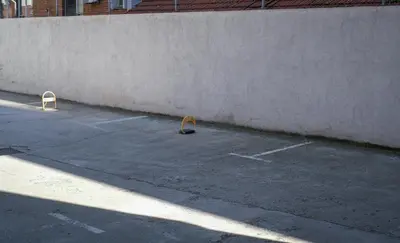 two barriers in a parking lot next to a wall at Apartment in Niš, Center! brand-new in Niš