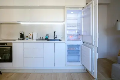 an open refrigerator with its door open in a kitchen at Apartment in Niš, Center! brand-new in Niš