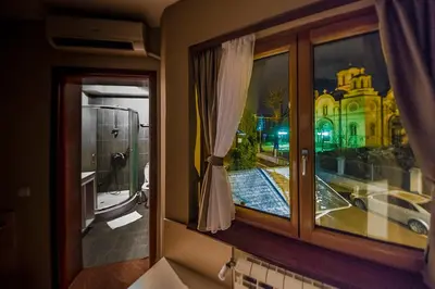 a window with a view of a building at Bell Inn in Leskovac