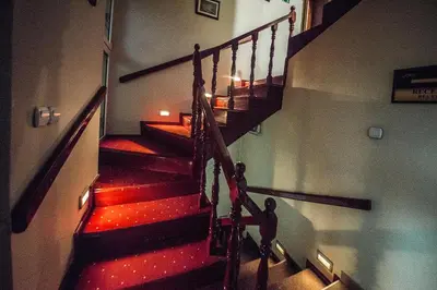 a staircase in a building with red lights on it at Bell Inn in Leskovac