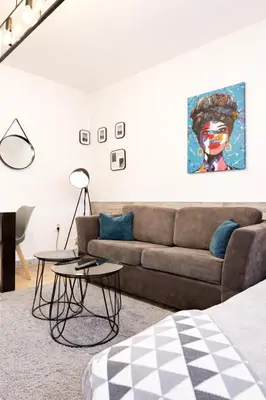 a living room with a couch and a table at Nilton Apartmans in Niš