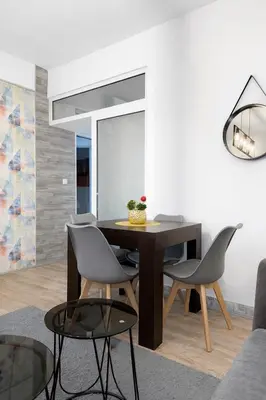 a dining room with a table and chairs at Nilton Apartmans in Niš