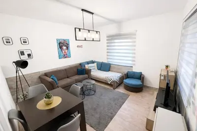 a living room with a couch and a table at Nilton Apartmans in Niš
