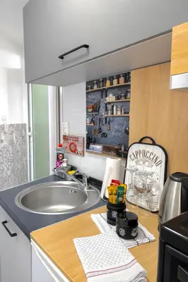 a kitchen with a sink and a counter top at Nilton Apartmans in Niš