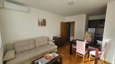 a living room with a couch and a dining room at Soko City Center & Parking Free in Soko Banja