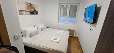 a bedroom with a bed with two towels on it at Soko City Center & Parking Free in Soko Banja