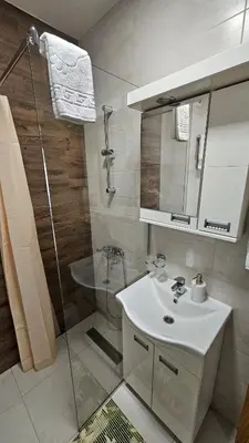 a bathroom with a shower and a sink and a mirror at Soko City Center & Parking Free in Soko Banja