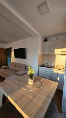 a living room with a table and a couch at Soko City Center & Parking Free in Soko Banja
