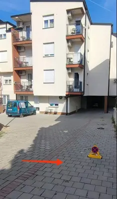 a red kite on the ground in front of a building at Soko City Center & Parking Free in Soko Banja