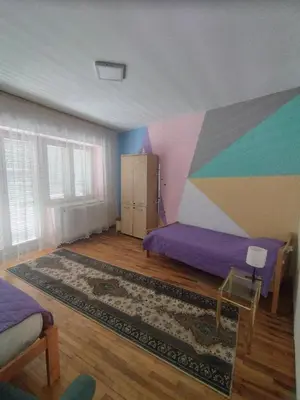 a bedroom with a painting on the wall at Villa Ema rooms in Niš