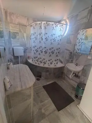 a bathroom with a tub and a sink at Villa Ema rooms in Niš