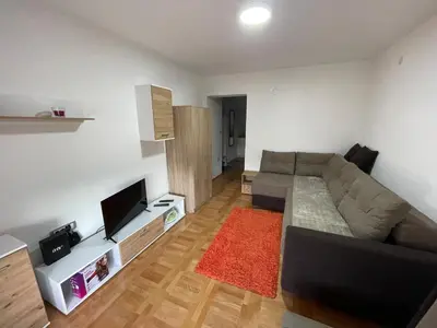 a living room with a couch and a flat screen tv at Apartman La Vista Sokobanja in Soko Banja