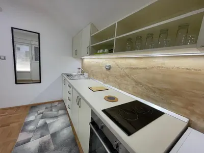 a kitchen with a stove and a counter top at Apartman La Vista Sokobanja in Soko Banja