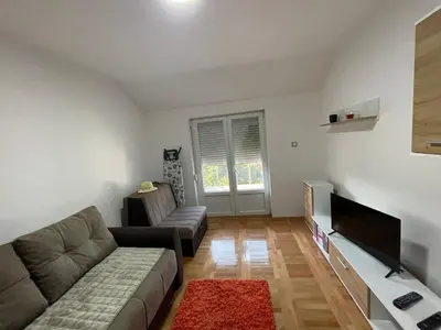 a living room with a couch and a flat screen tv at Apartman La Vista Sokobanja in Soko Banja