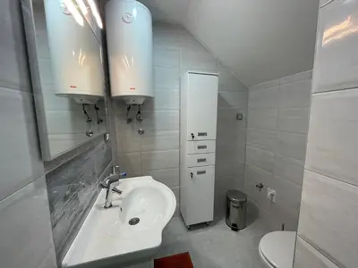 a white bathroom with a sink and a mirror at Apartman La Vista Sokobanja in Soko Banja