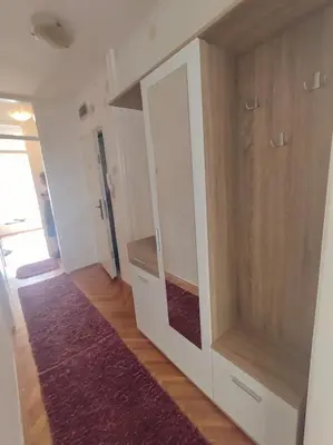 a room with a large cabinet with a mirror at Apartman Centar in Pirot