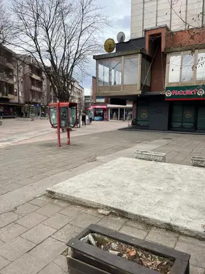 an empty street in front of a building at Apartman Centar in Pirot