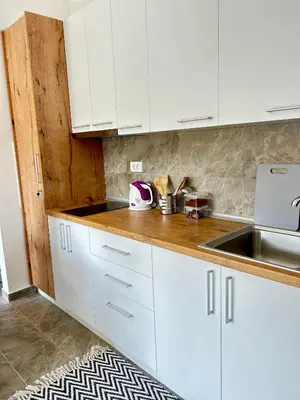 a kitchen with white cabinets and a sink at Apartman Viny in Soko Banja