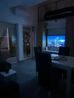 a living room with a view of a city at night at Apartman Viny in Soko Banja