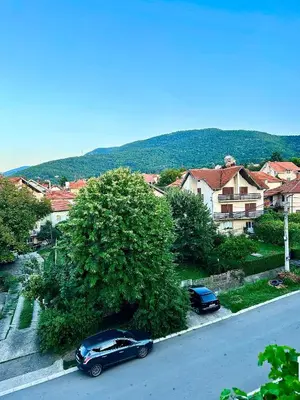 a black car parked on the side of a street at Apartman Viny in Soko Banja
