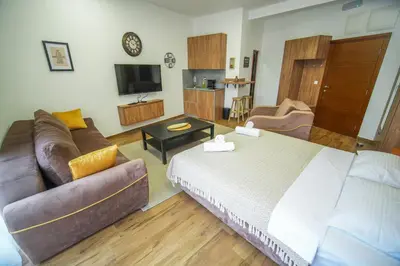 a living room with a large bed and a couch at PRENOCISTE SOLE in Vranje