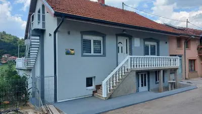 a house with a staircase on the side of it at Rooms Enna in Dimitrovgrad