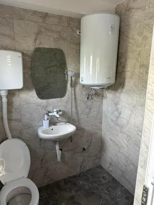 a bathroom with a toilet and a sink at Rooms Enna in Dimitrovgrad