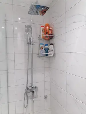 a bathroom with a shower with white tiles at DIV Bor in Bor