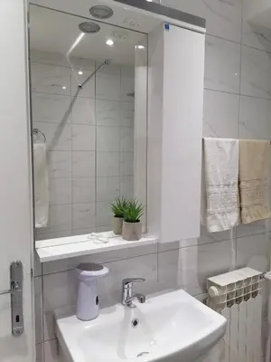 a white bathroom with a sink and a mirror at DIV Bor in Bor