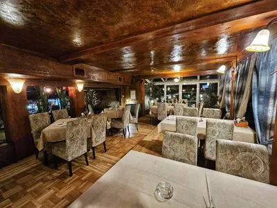 a restaurant with tables and chairs in a room at Hotel Koliba na Grza in Kilsura