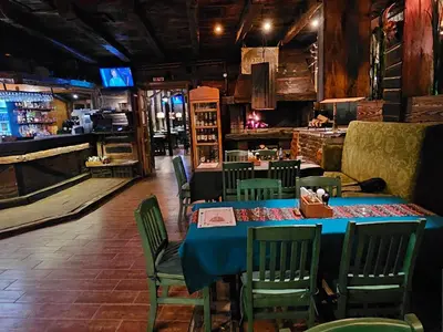 a dining room with a blue table and chairs at Hotel Koliba na Grza in Kilsura