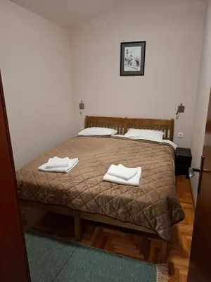 a bedroom with a bed with two white towels on it at Hotel Koliba na Grza in Kilsura