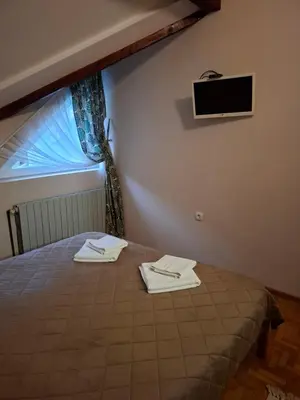 a bedroom with a bed with two towels on it at Hotel Koliba na Grza in Kilsura
