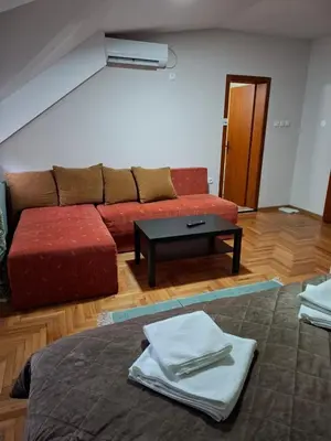 a living room with a couch and a table at Hotel Koliba na Grza in Kilsura