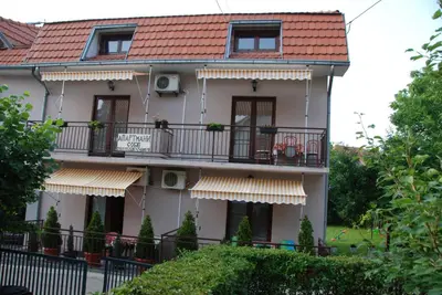 a building with balconies and a red roof at Apartments Hadži in Soko Banja