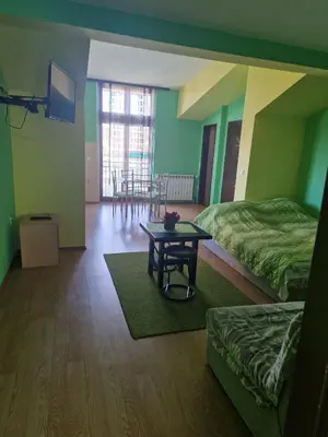 a room with two beds and a table in it at Apartments Hadži in Soko Banja