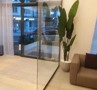 a living room with a couch and a potted plant at Prenoćište SRBIJA in Surdulica