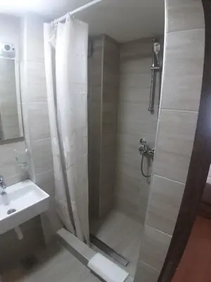a bathroom with a shower and a sink at Prenoćište SRBIJA in Surdulica