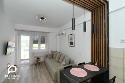 a living room with a couch and a table at Petković apartmani 87 in Jagodina