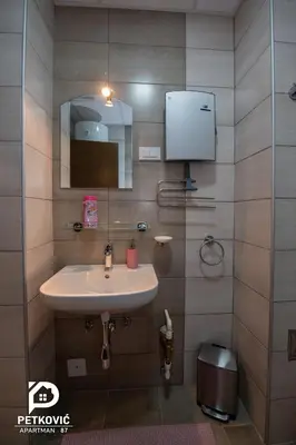 a bathroom with a sink and a mirror at Petković apartmani 87 in Jagodina