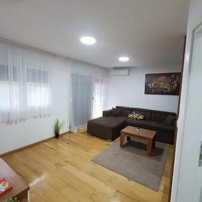 a living room with a couch and a table at APARTMANI PORTA INFINITAS centar in Vrnjačka Banja