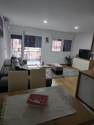 a living room with a couch and a table at APARTMANI PORTA INFINITAS centar in Vrnjačka Banja
