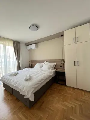 a bedroom with a large bed with towels on it at Vila Simfonija in Vrnjačka Banja