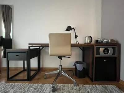 a desk with a chair and a desk with a microwave at Vila Simfonija in Vrnjačka Banja
